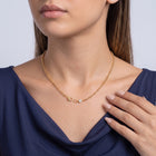Hand at the collar of a woman wearing the Maeve Classic Necklace