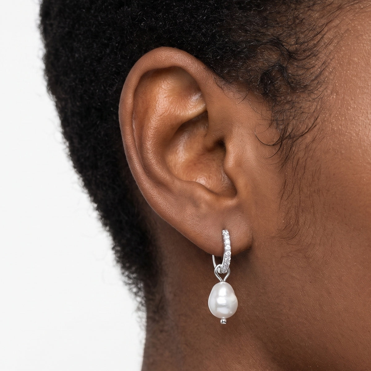 Close-up of the Lelice Margo Silver Huggies on the ear