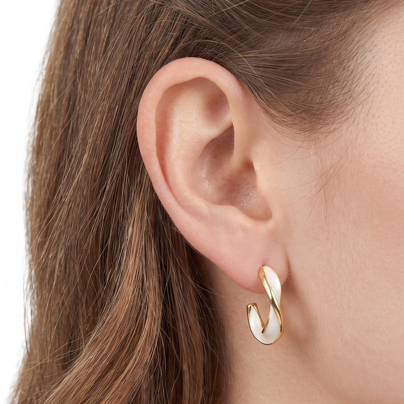 Close-up of the Lelice Margot Twist Hoops in gold on the ear