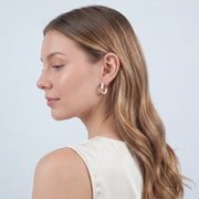 Model wearing the Lelice Margot Twist Hoops in gold, three-quarter back view