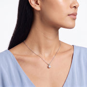 Three-quarter profile of woman wearing Marianne silver solitaire necklace