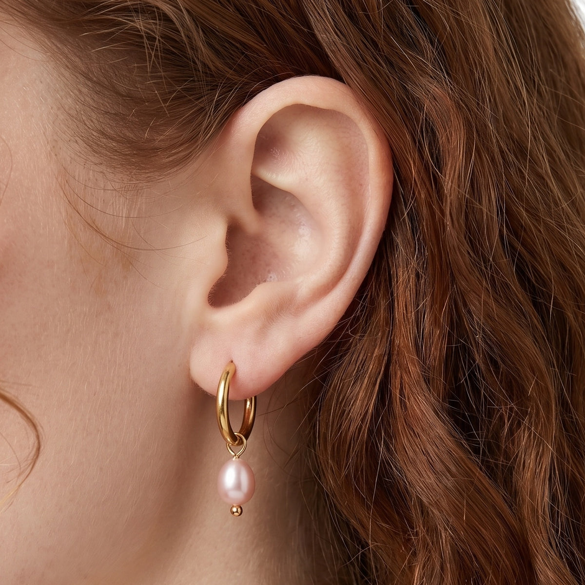Close-up of the Lelice Marie Pearl Earrings in gold on the ear