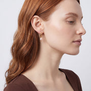 Model wearing the Lelice Marie Pearl Earrings in gold, sculpted side profile