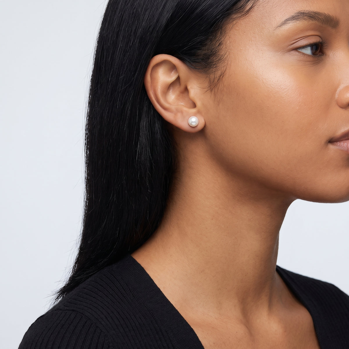Model wearing the Lelice Matilda Pearl Earrings in silver, ear and jaw, slightly wider