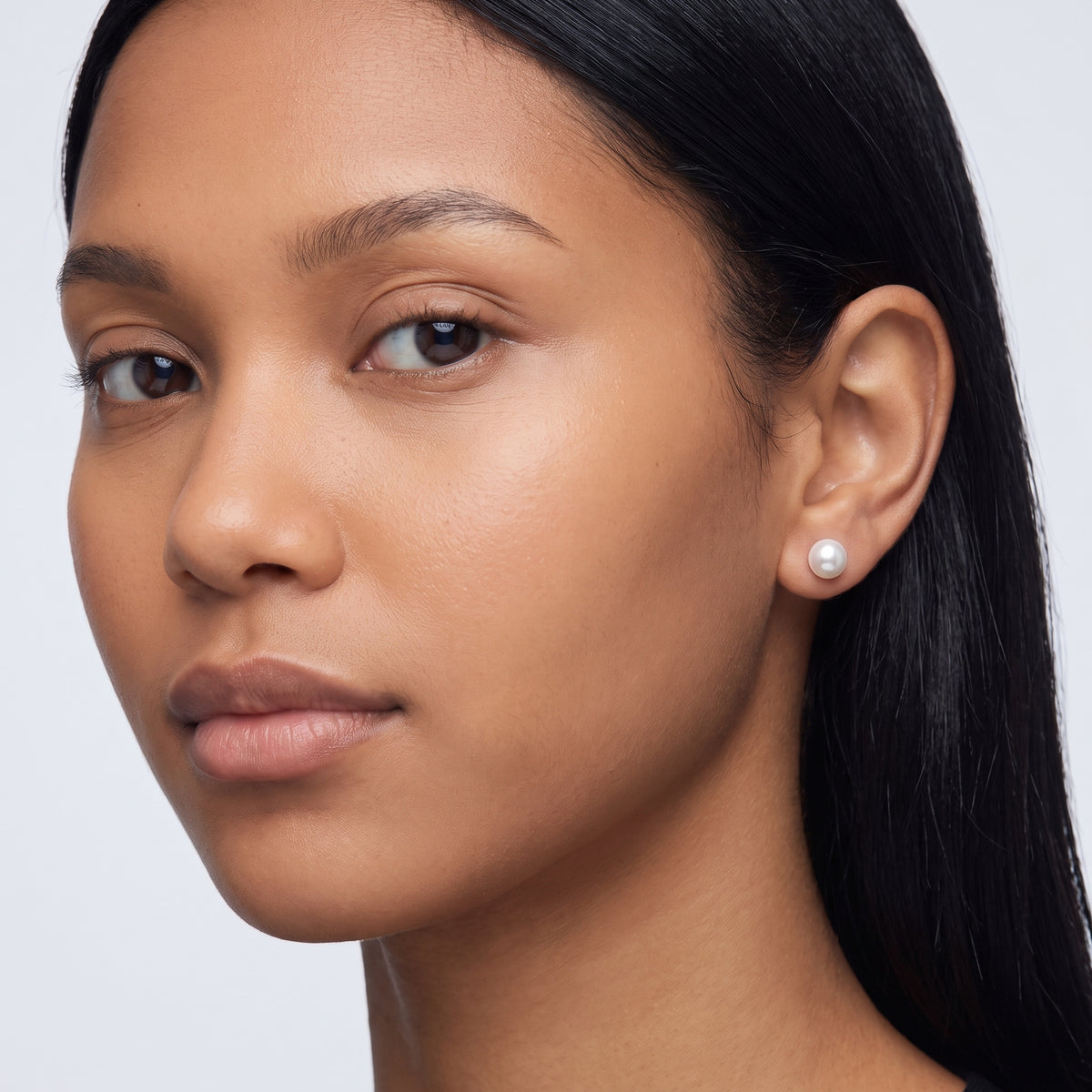 Model wearing the Lelice Matilda Pearl Earrings in silver, three-quarter face close-up