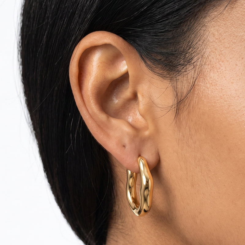 Close-up of the Lelice Maya Hoop Earrings in gold on the ear
