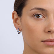 Model wearing the Lelice Midnight Sapphire Hoops in silver, one-eye face close-up