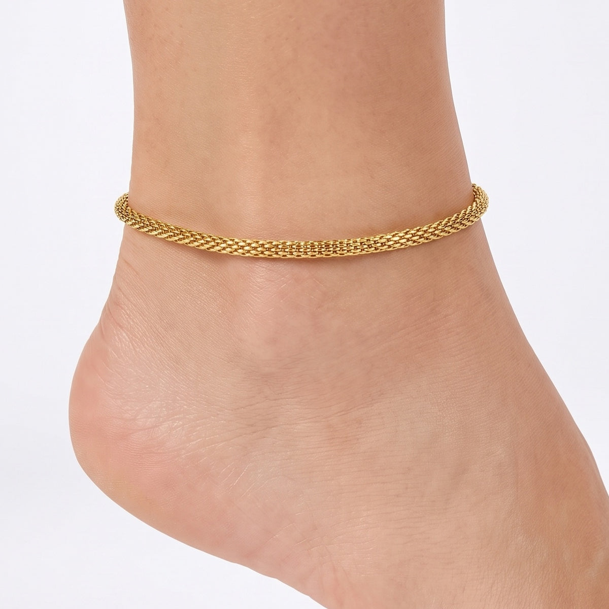 Close-up of the Lelice Monaco Golden Braid Anklet on a woman's ankle