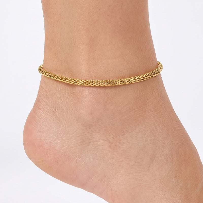 Close-up of the Lelice Monaco Golden Braid Anklet on a woman's ankle