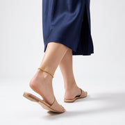 Woman walking away in the Monaco Golden Braid Anklet, heel lifted