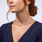 Low-angle portrait of a woman wearing the Monaco Tennis Choker