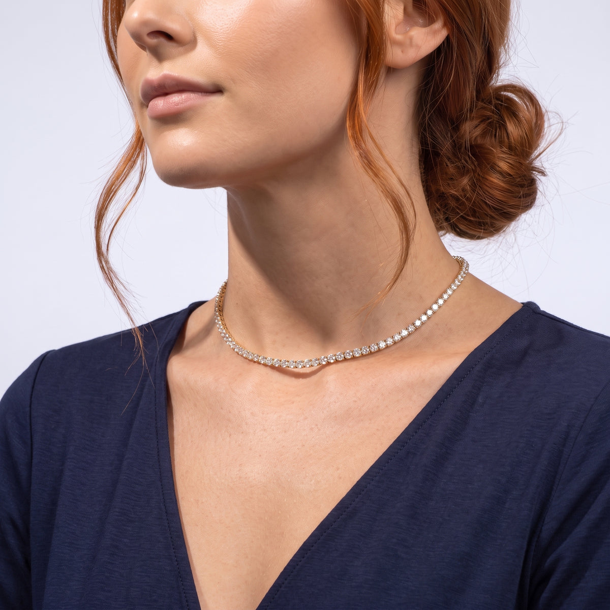 Low-angle portrait of a woman wearing the Monaco Tennis Choker