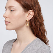 Model wearing the Lelice Nadia Gold Textured Teardrop Statement Earrings, sculpted side profile
