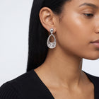 Model wearing the Lelice Nadia Silver Textured Teardrop Statement Earrings, ear and jaw, slightly wider