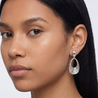 Model wearing the Lelice Nadia Silver Textured Teardrop Statement Earrings, three-quarter face close-up
