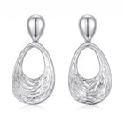 Lelice Nadia Silver Textured Teardrop Statement Earrings on a white background