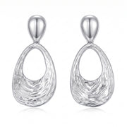 Lelice Nadia Silver Textured Teardrop Statement Earrings on a white background