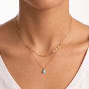 Close-up of the Lelice Naxos Opal Necklace in gold at the collarbone