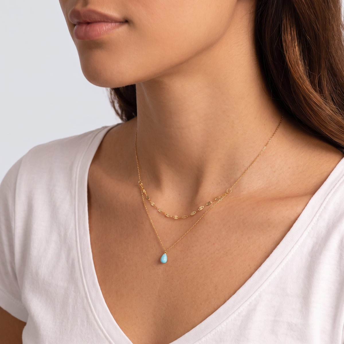Woman turned three-quarters wearing the Naxos Opal Necklace