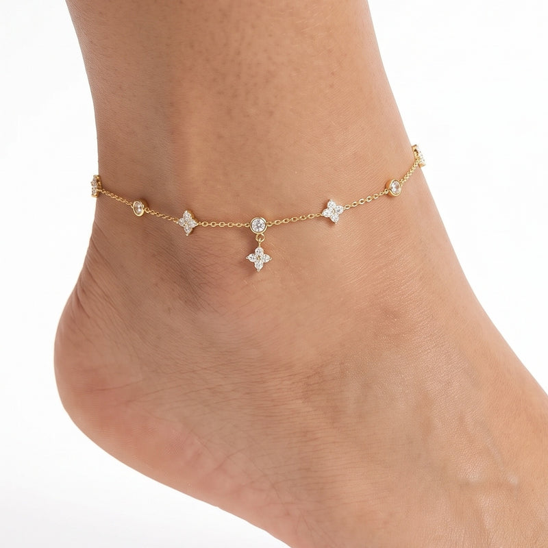 Close-up of the Lelice Nia Gold Clover Anklet on a woman's ankle