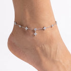 Close-up of the Lelice Nia Silver Clover Anklet on a woman's ankle