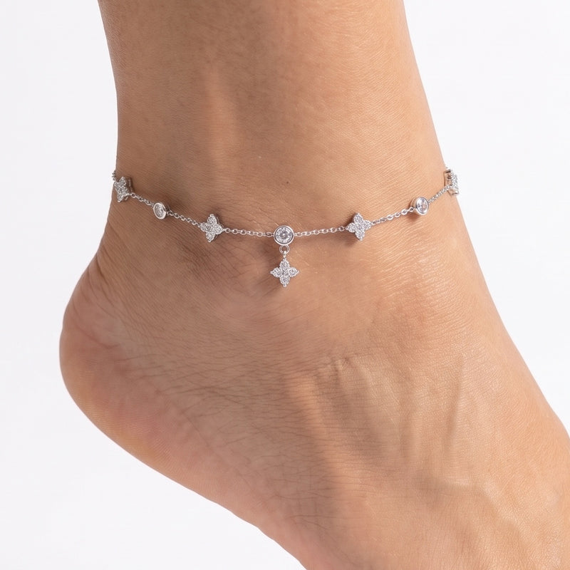 Close-up of the Lelice Nia Silver Clover Anklet on a woman's ankle