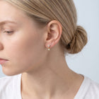 Model wearing the Lelice Nina Petite Studs in gold, low bun, ear and neck