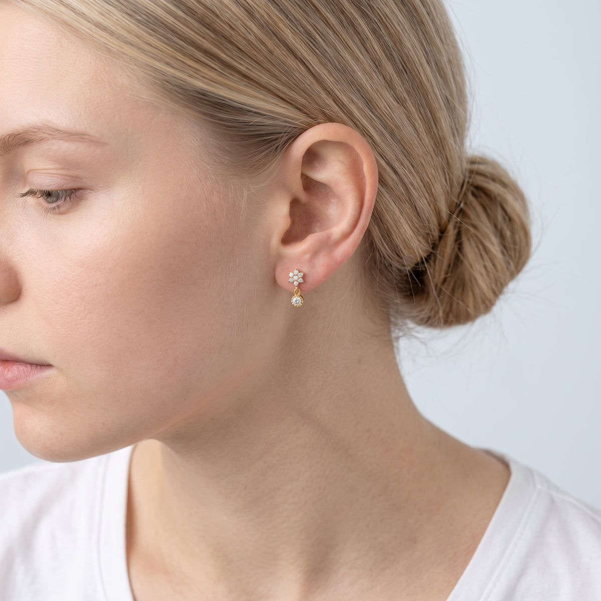 Model wearing the Lelice Nina Petite Studs in gold, low bun, ear and neck