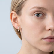 Model wearing the Lelice Nina Petite Studs in gold, one-eye face close-up
