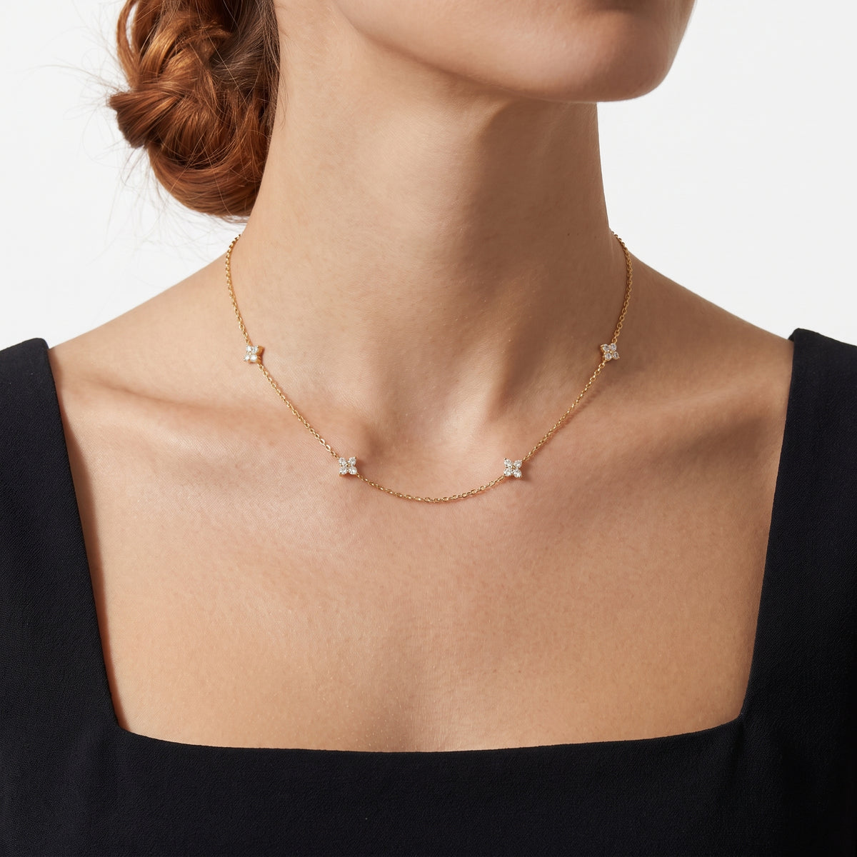 Close-up of the Lelice Noémie Crystal Necklace in gold at the collarbone