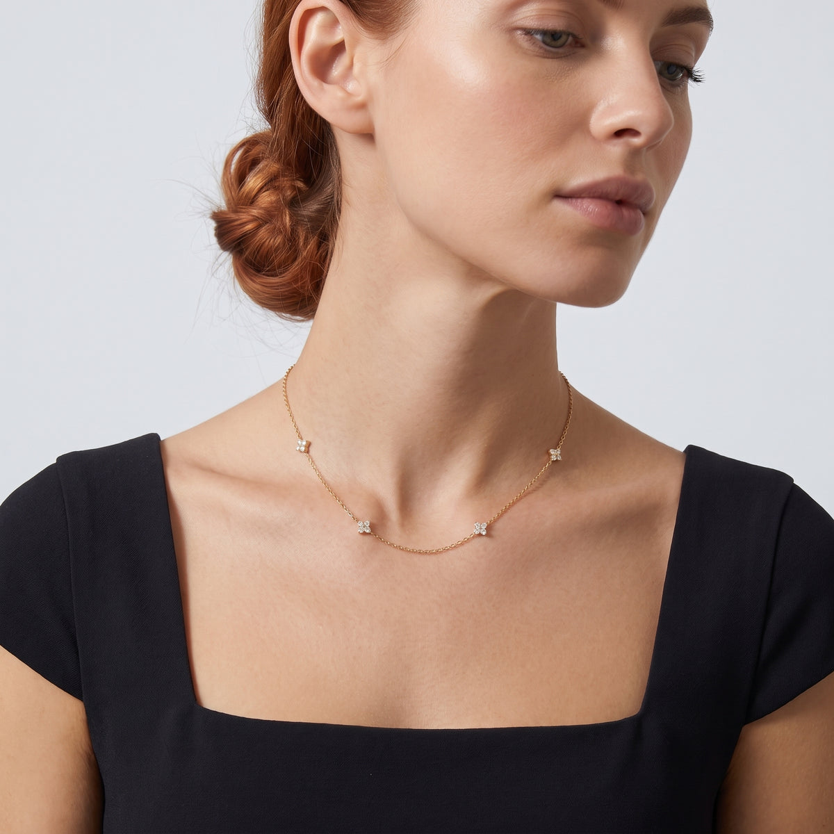 Neckline profile with hair up, wearing the Noémie Crystal Necklace