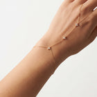 Close-up of the Lelice Noémie Fine Bracelet in gold on the wrist and hand