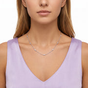 Close-up of the Lelice Nora Zircon Necklace in silver at the collarbone