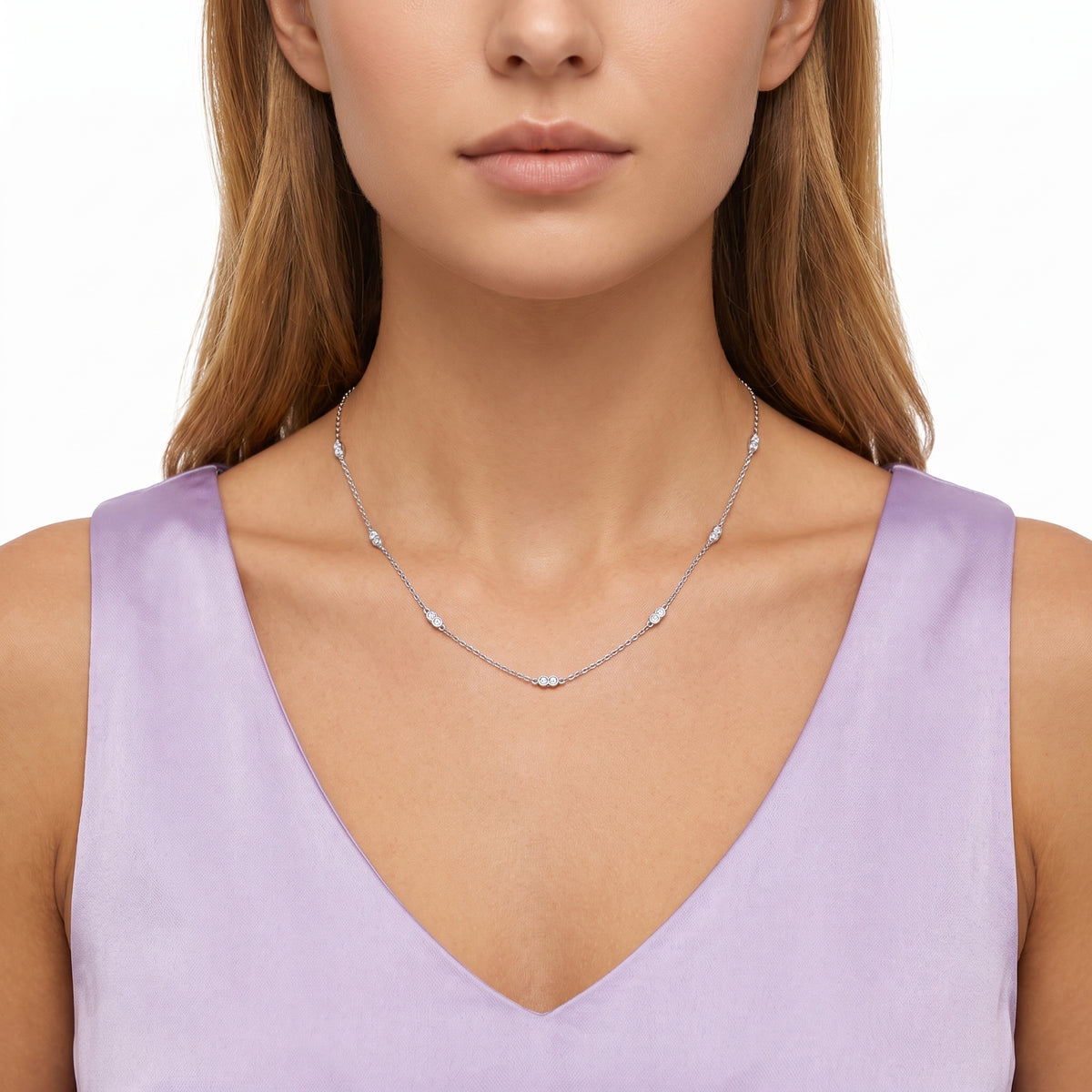 Close-up of the Lelice Nora Zircon Necklace in silver at the collarbone