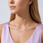 Woman in soft side light wearing the Nora Zircon Necklace