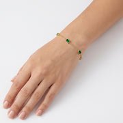 Wrist wearing Lelice gold emerald green station bracelet Olive
