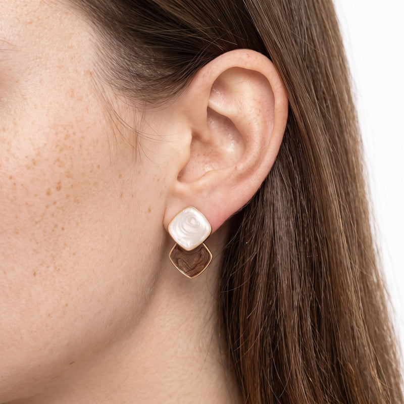 Close-up of the Lelice Ondine Mocha Marbled Earrings in gold on the ear