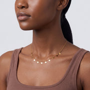 Side profile of the neckline with the Penny Charm Necklace
