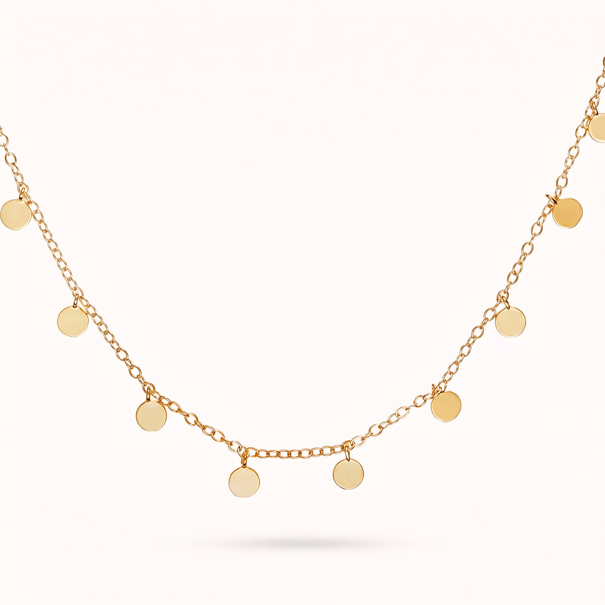 Lelice Penny Charm Necklace in gold on a white background