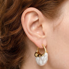 Close-up of the Lelice Perla Gold Baroque Pearl Chunky Hoop Earrings on the ear