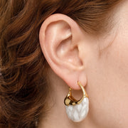 Close-up of the Lelice Perla Gold Baroque Pearl Chunky Hoop Earrings on the ear