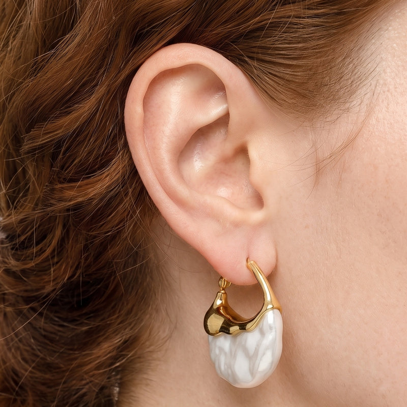 Close-up of the Lelice Perla Gold Baroque Pearl Chunky Hoop Earrings on the ear