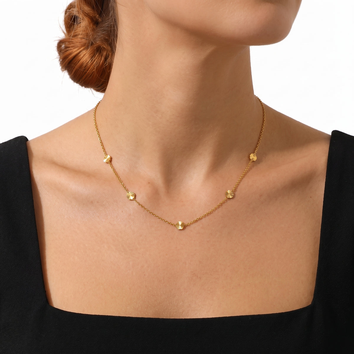 Close-up of the Lelice Petite Blossom Necklace in gold at the collarbone