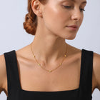 Neckline profile with hair up, wearing the Petite Blossom Necklace