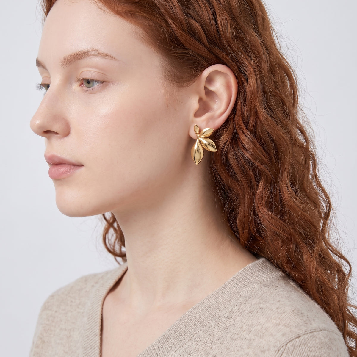 Model wearing the Lelice Puffy Petal Statement Studs in gold, sculpted side profile