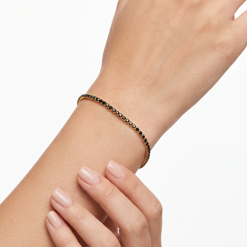 Wrist wearing Lelice gold black crystal tennis bracelet Raven