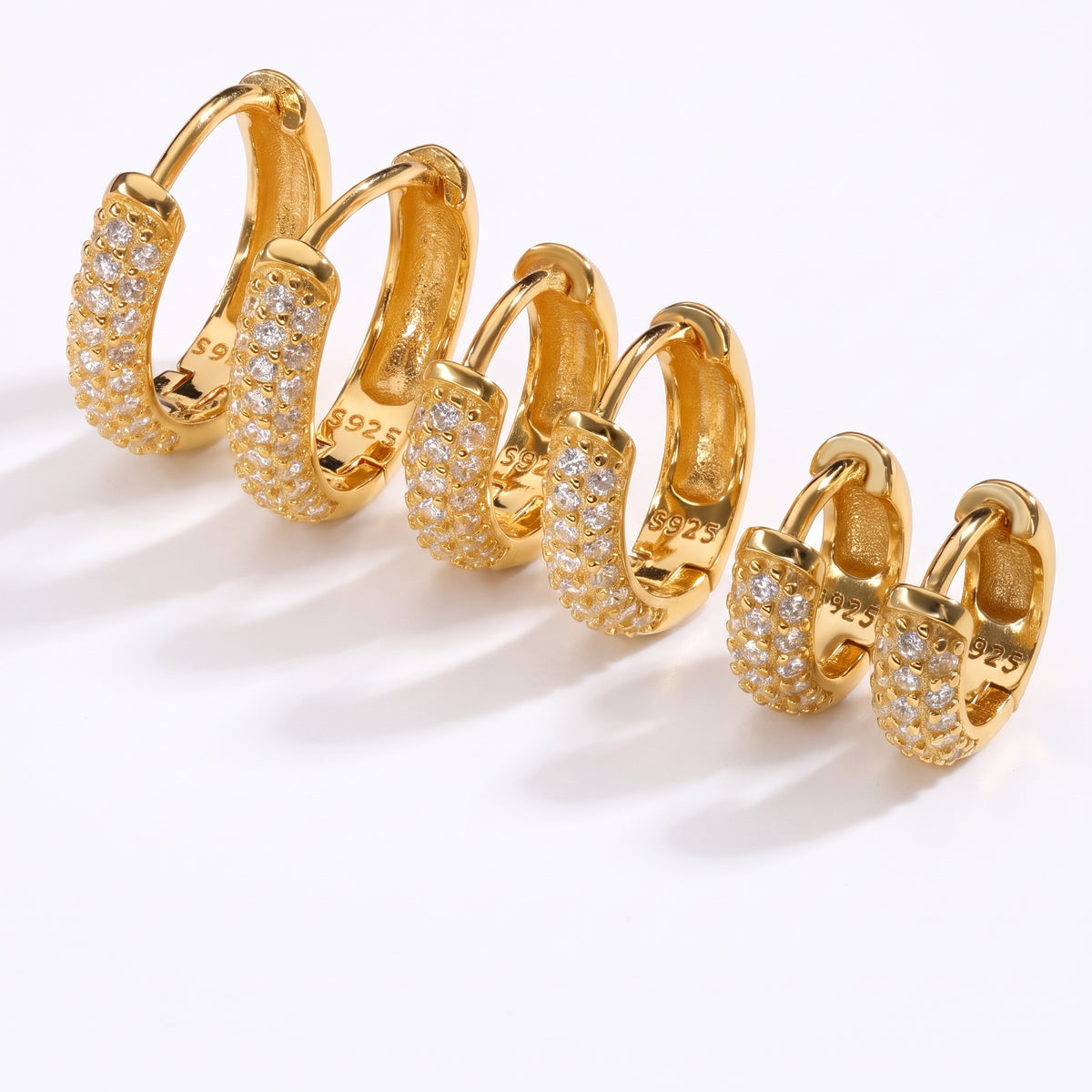 Lelice Remi Huggie Hoops in gold on a white background