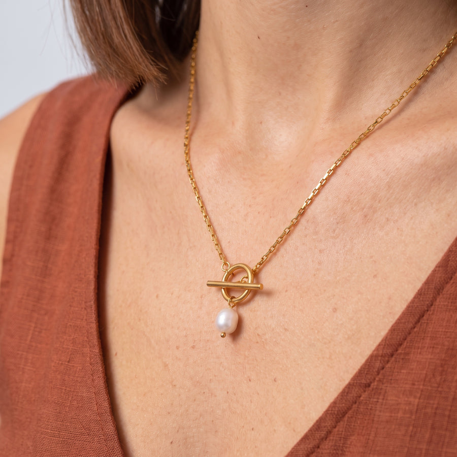 Close-up of the Riviera Gold Pearl Necklace resting on the skin