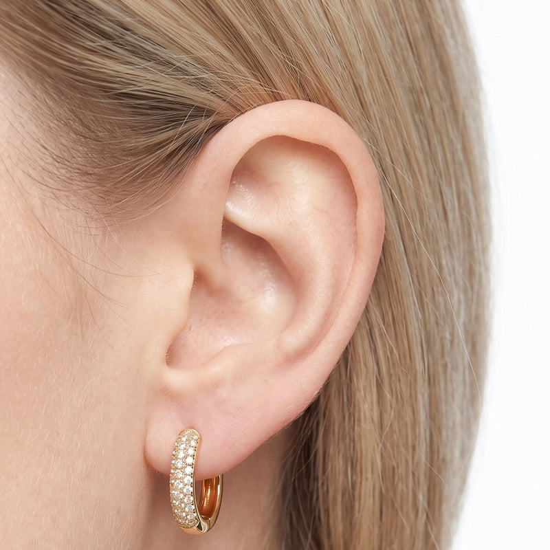 Close-up of the Lelice Rose Sparkle Hoops in gold on the ear