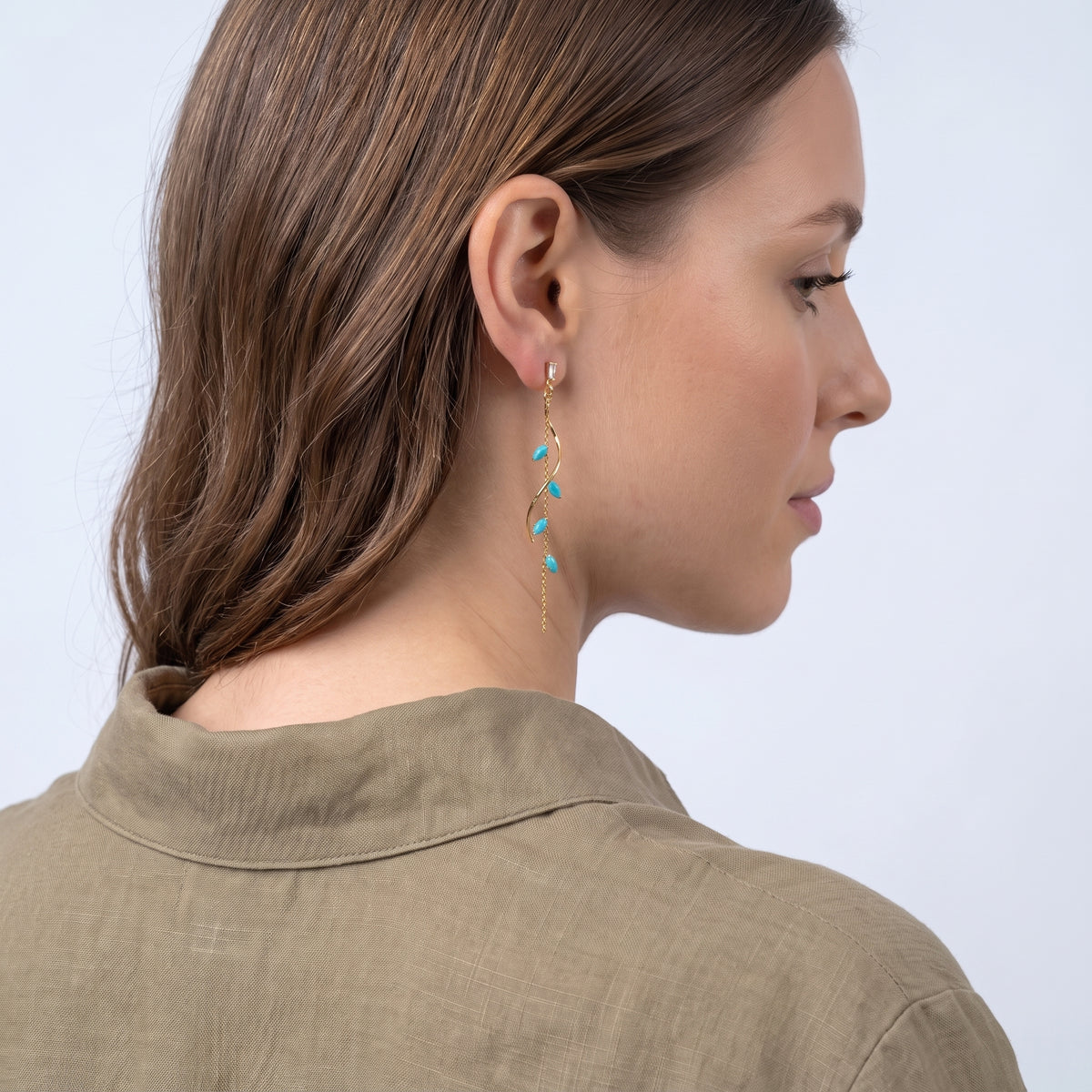 Model wearing the Lelice Santorini Turquoise Drops in gold, three-quarter back view
